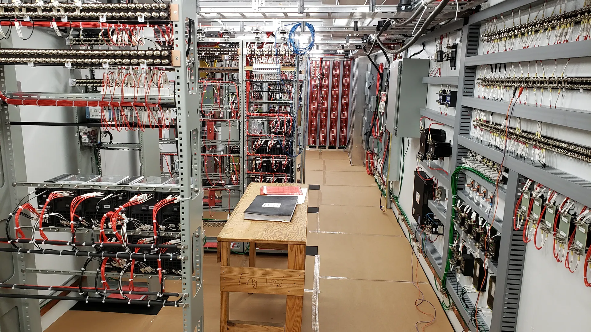 CIL hut interior with relay racks and testing bench
