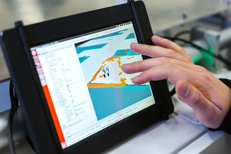 Engineer using rugged field tablet with signalling schematic