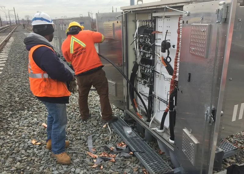 Signal engineers installing power cables trackside